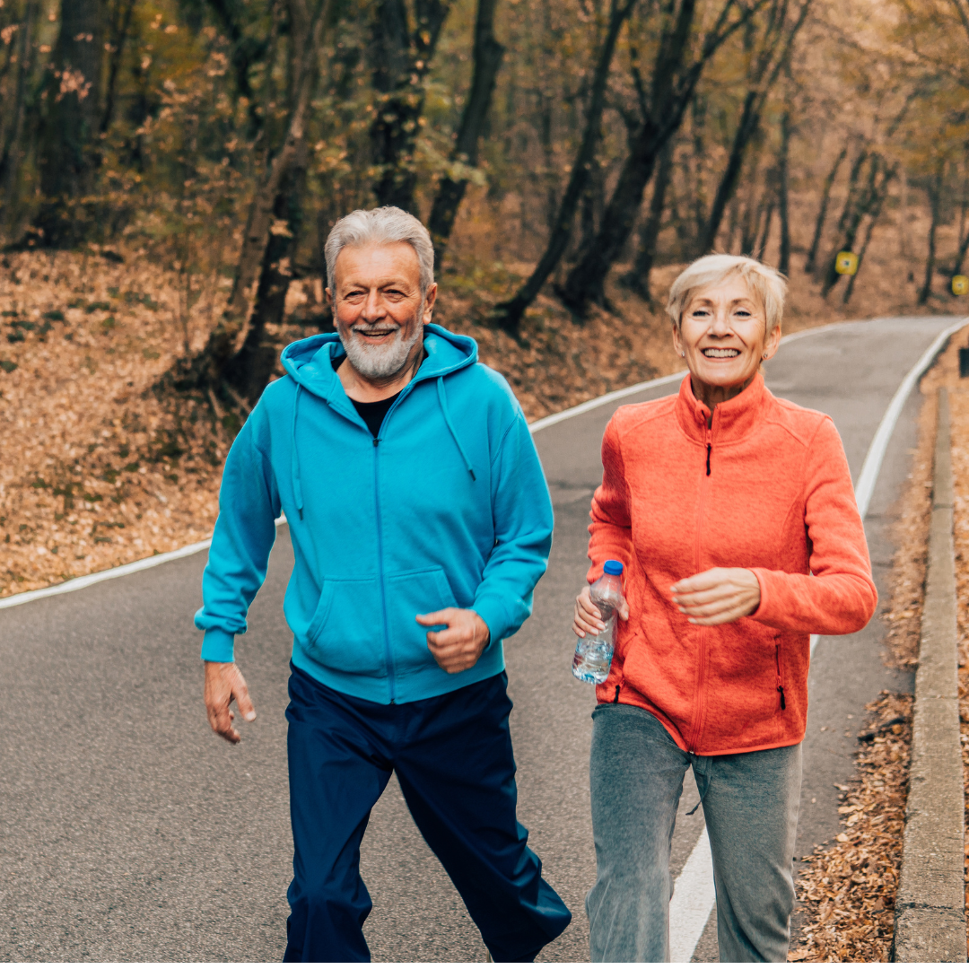 Older couple walking outdoors together as part of a heart health program in Greensboro, NC