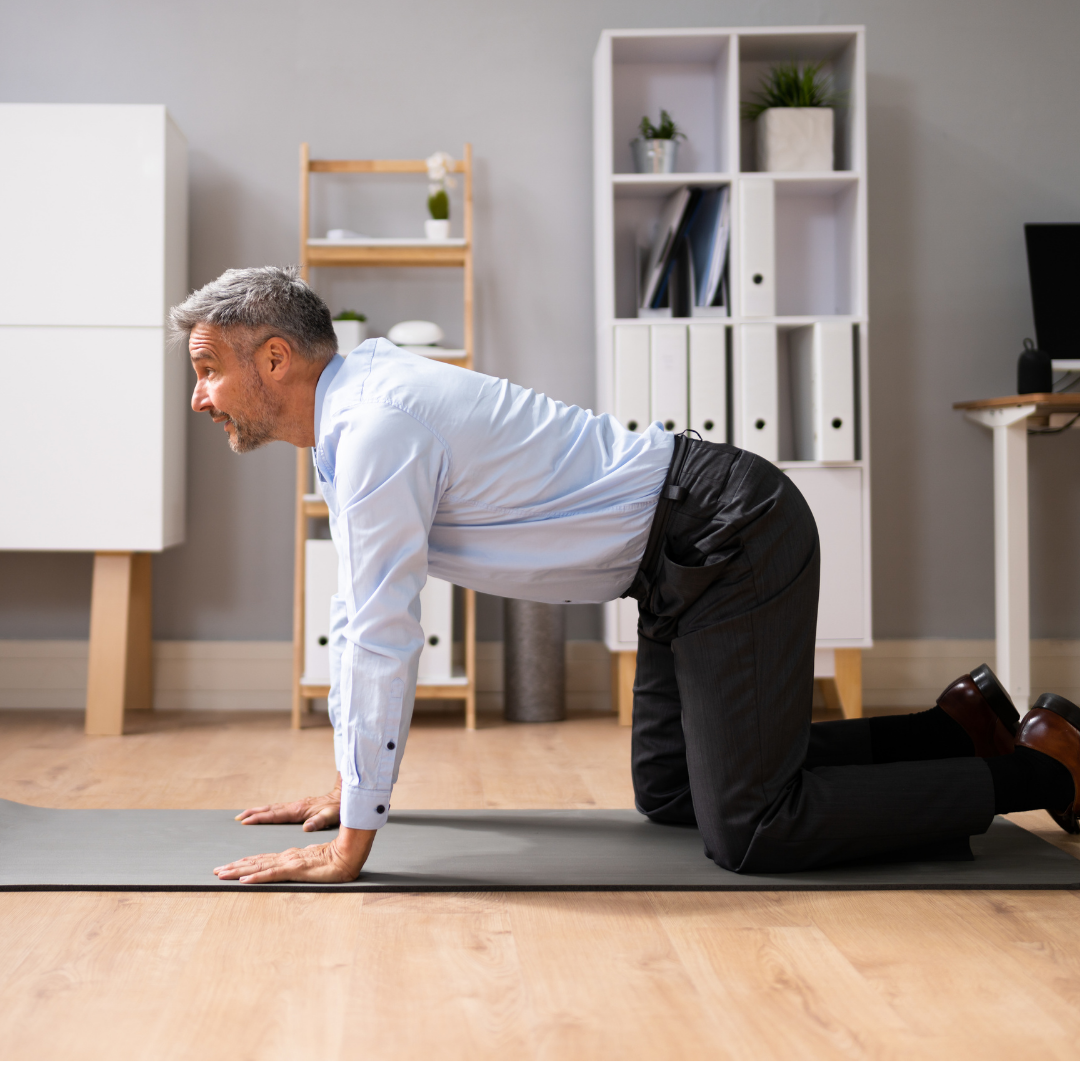 Male adult doing the cat cow streching position for his joints