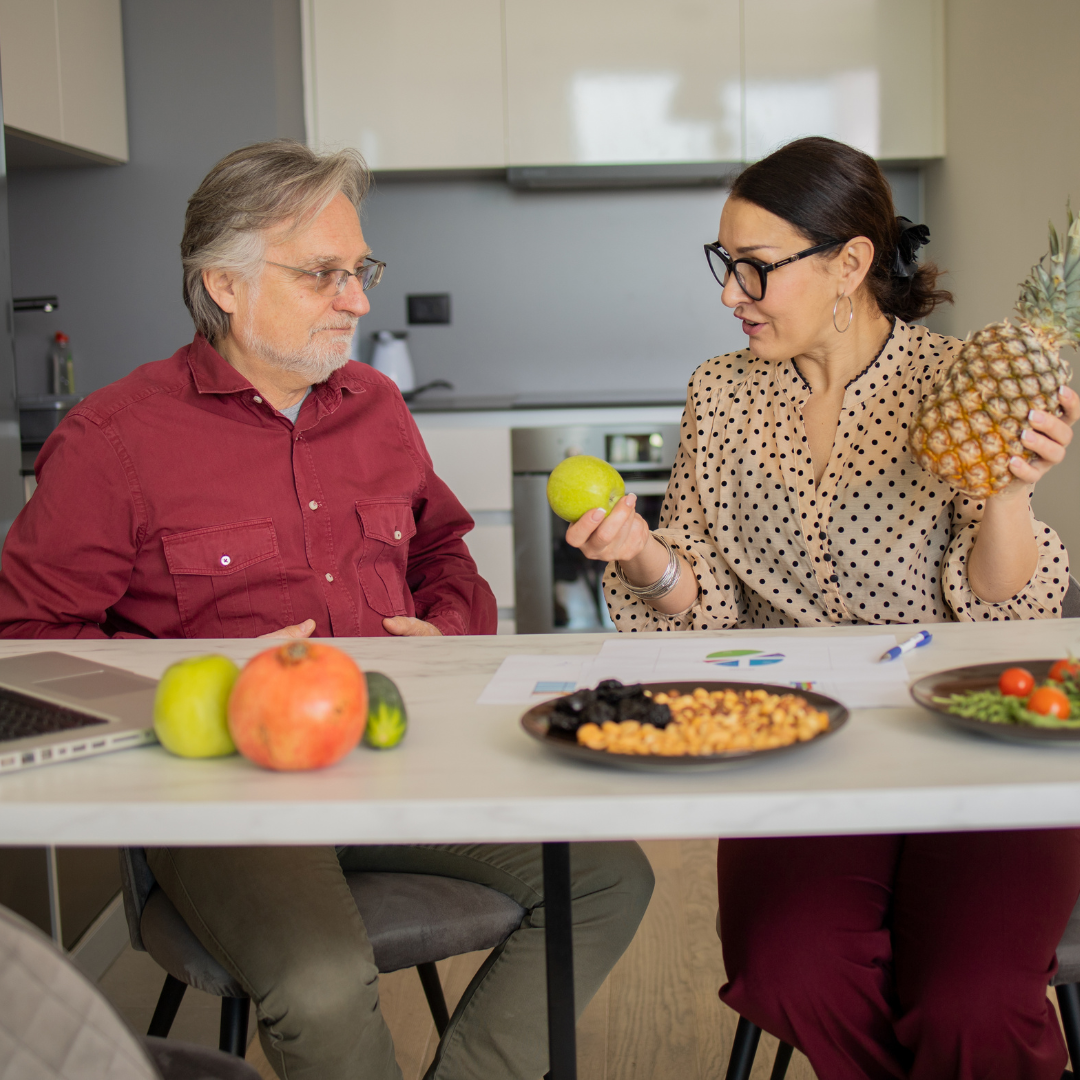 Nutrition coach and client preparing a protein-rich meal together at One Wellness Center in Greensboro, NC